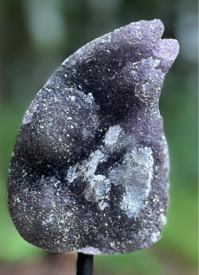 Decorative stone on a stand with a natural outdoor background